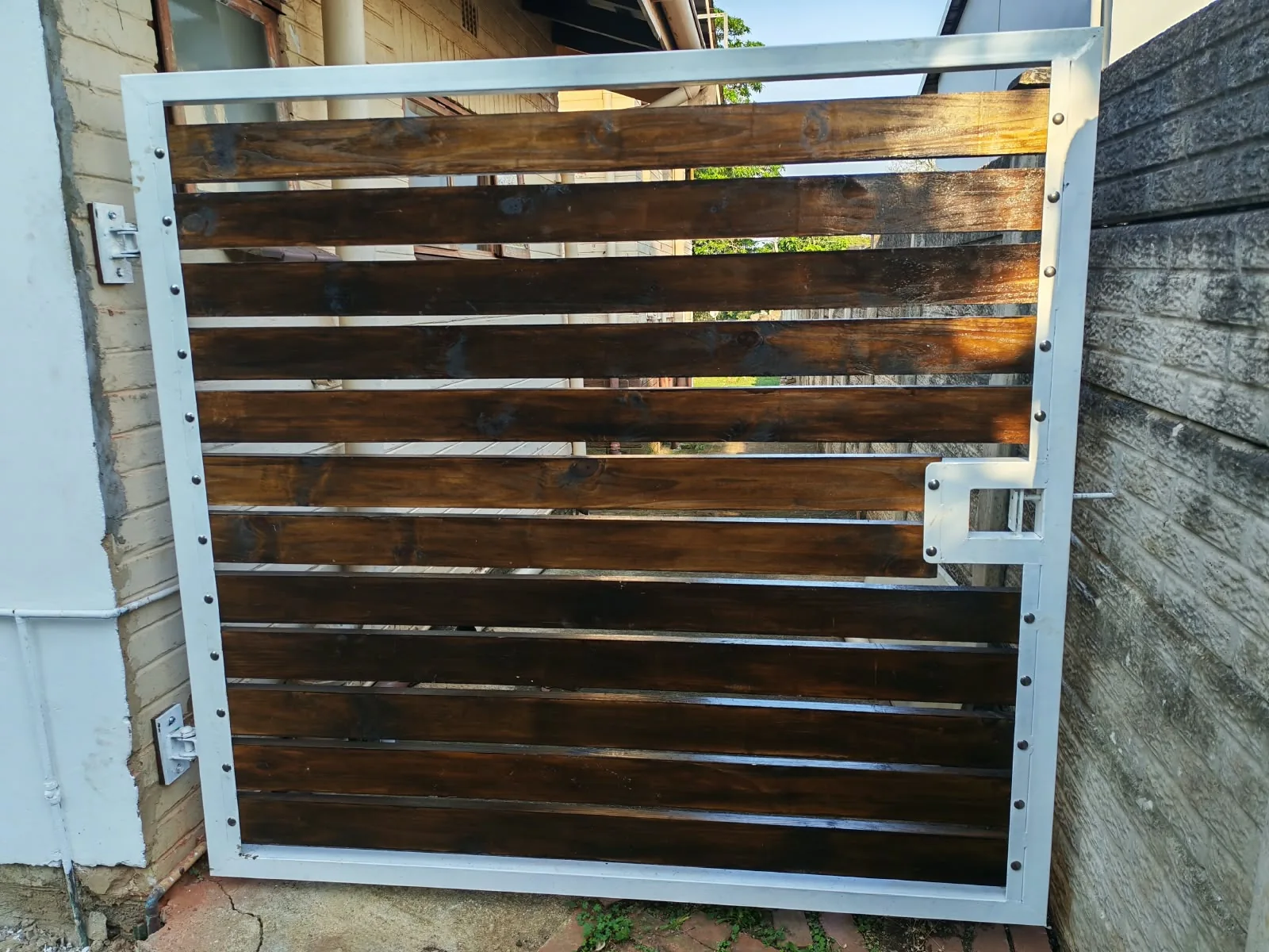 Close view of a framed timber-look pedestrian gate