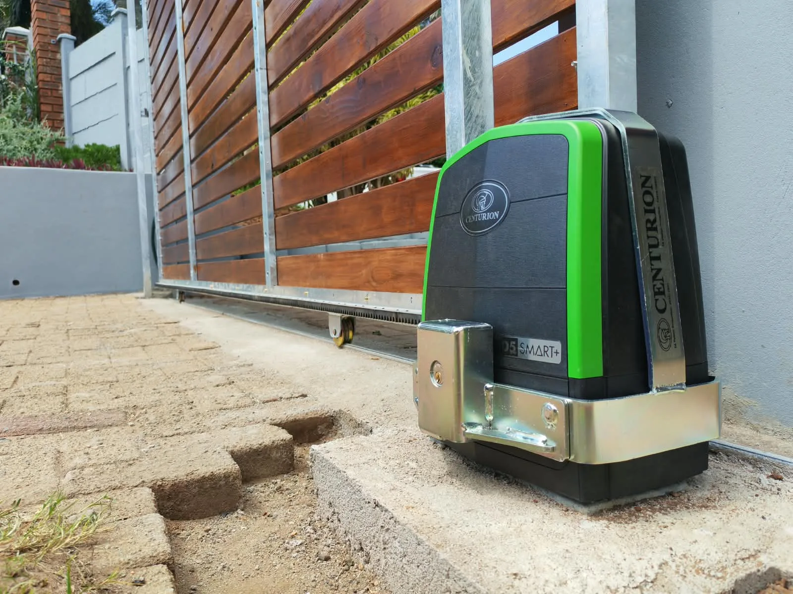Gate motor installed beside a timber-look driveway gate